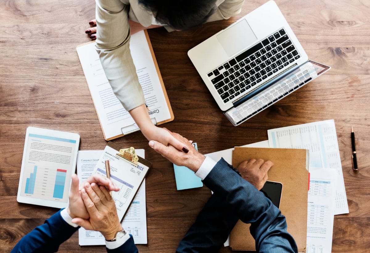 business-people-shaking-hands-together-1-1